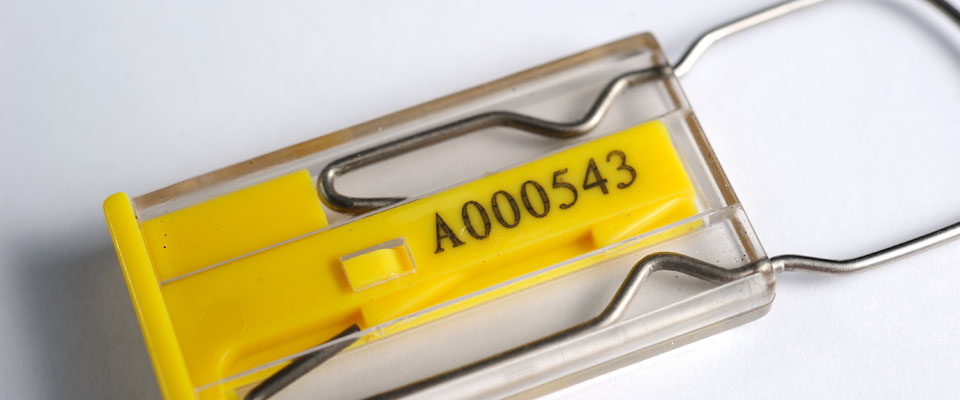 Laser engraved printing is protected by a clear encapsulation which also serves as a window into the locking mechanism so that it can be inspected for security.